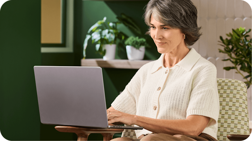 Image of a person sitting and looking at a laptop. The visual suggests how users can learn about 11 of the best web analytics tools.