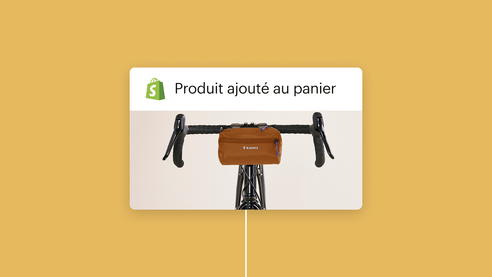 Sacoche de guidon marron montée sur un guidon de vélo noir avec le logo Shopify et le texte « Produit ajouté au panier » au-dessus